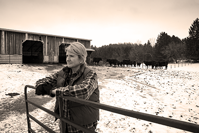 IMAGE: woman outdoors in corral, appears frustrated.